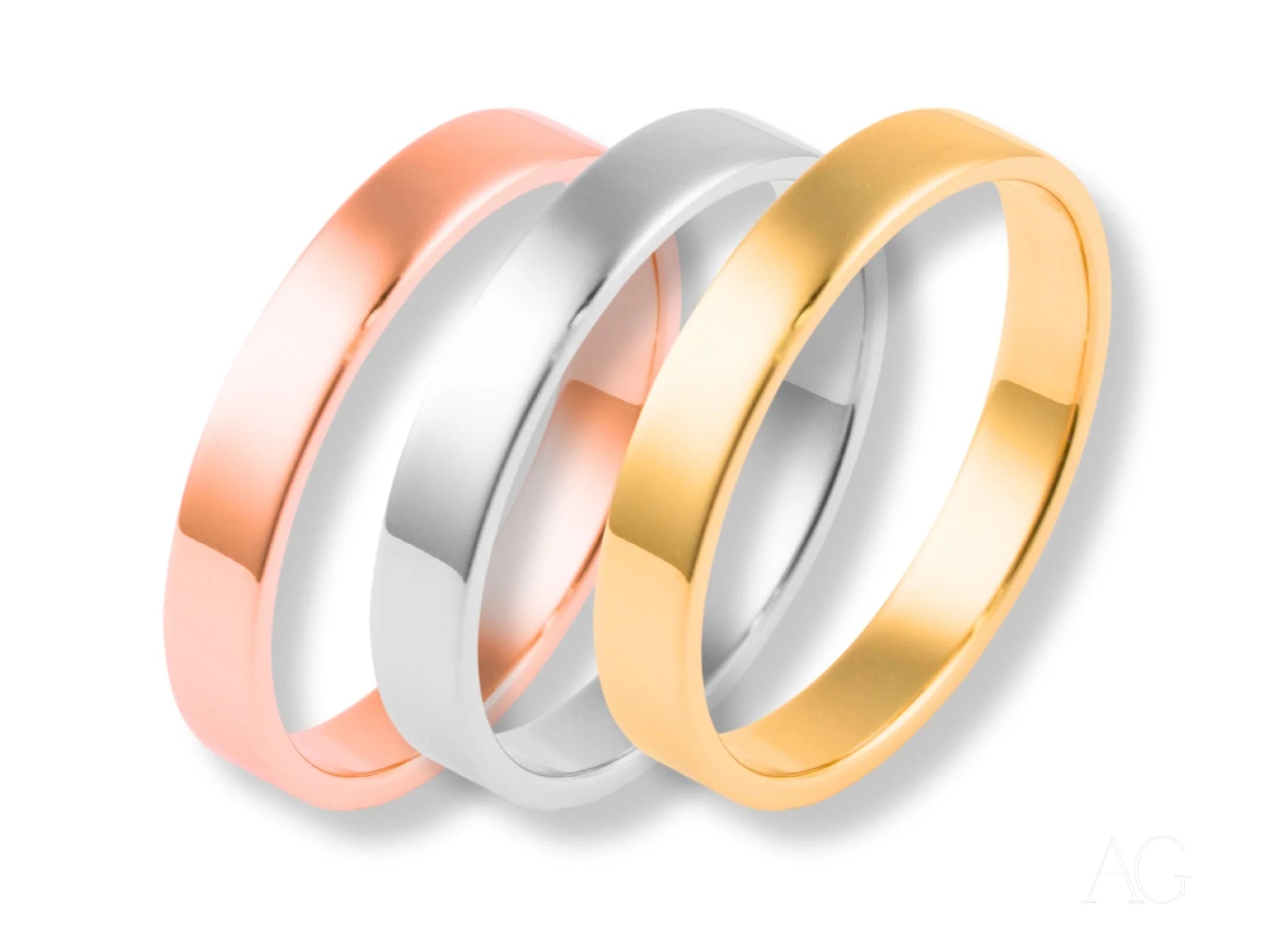 Three minimalistic 18k gold wedding bands in rose, white, and yellow gold from Essence Collection