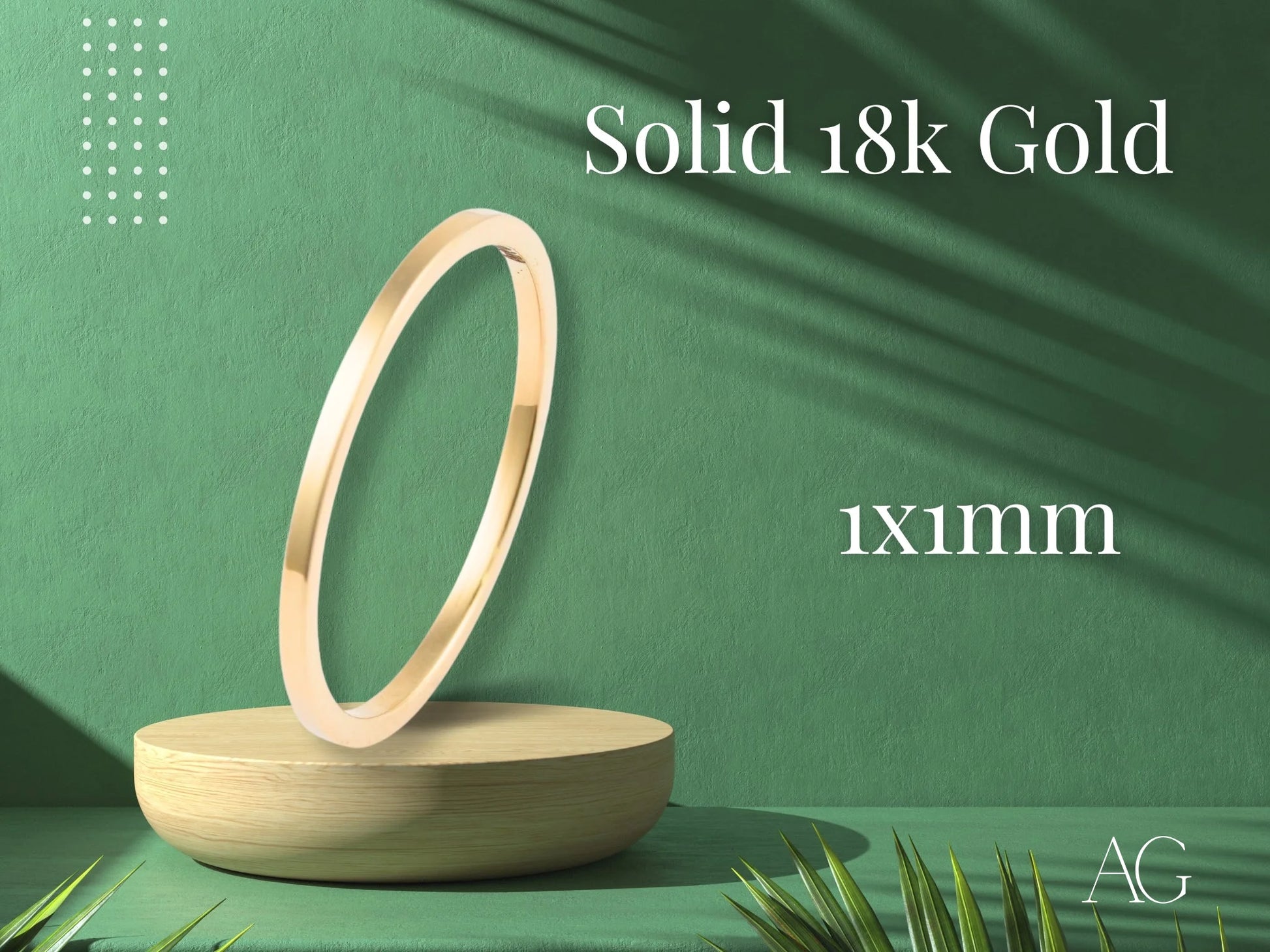 Thin circular solid gold ring on a wooden stand, showcasing timeless minimalist design