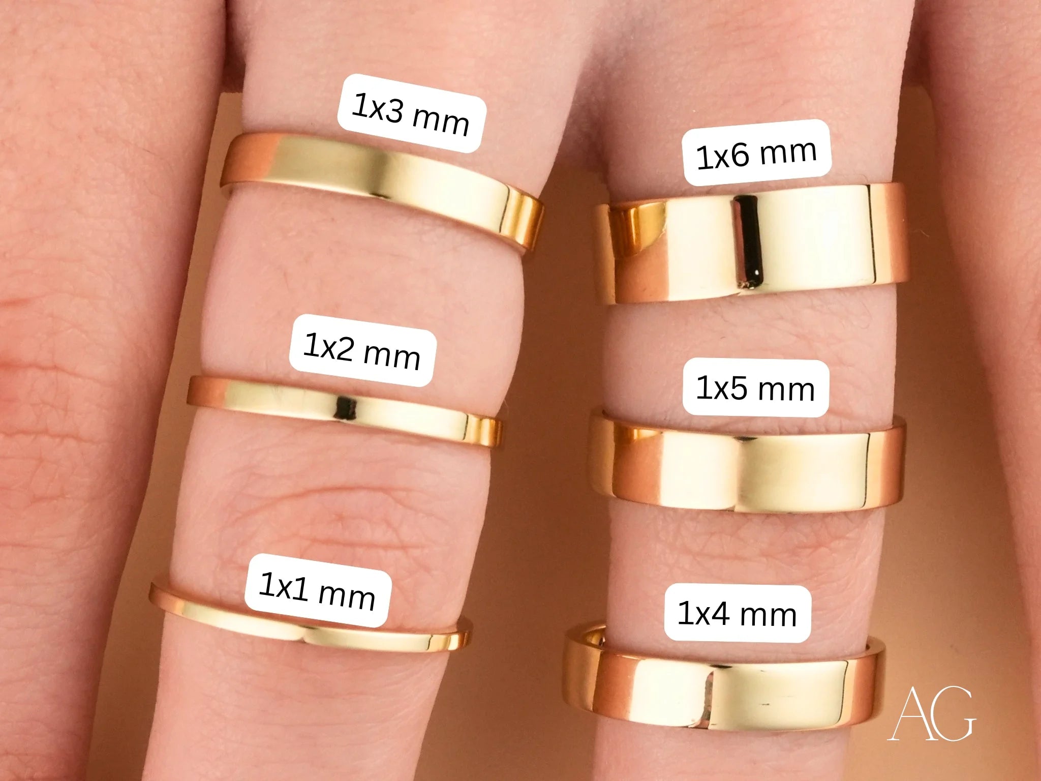 Gold rings of varying widths on fingers from the Essence Collection, Minimalistic 18k Gold