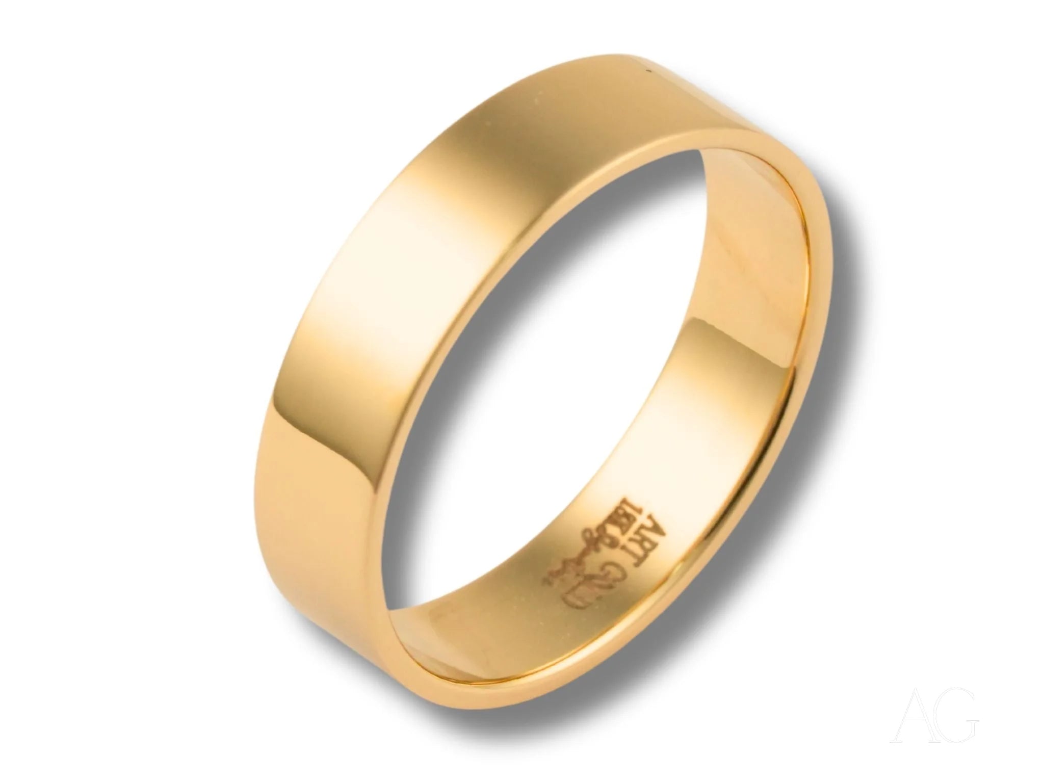 Gold wedding band from Essence Collection featuring a simple, classic design in 18k gold