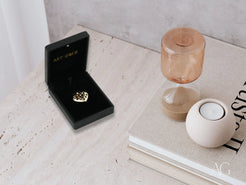 Diamond ring in black velvet box with 18k gold Eternal Heart pendant inside