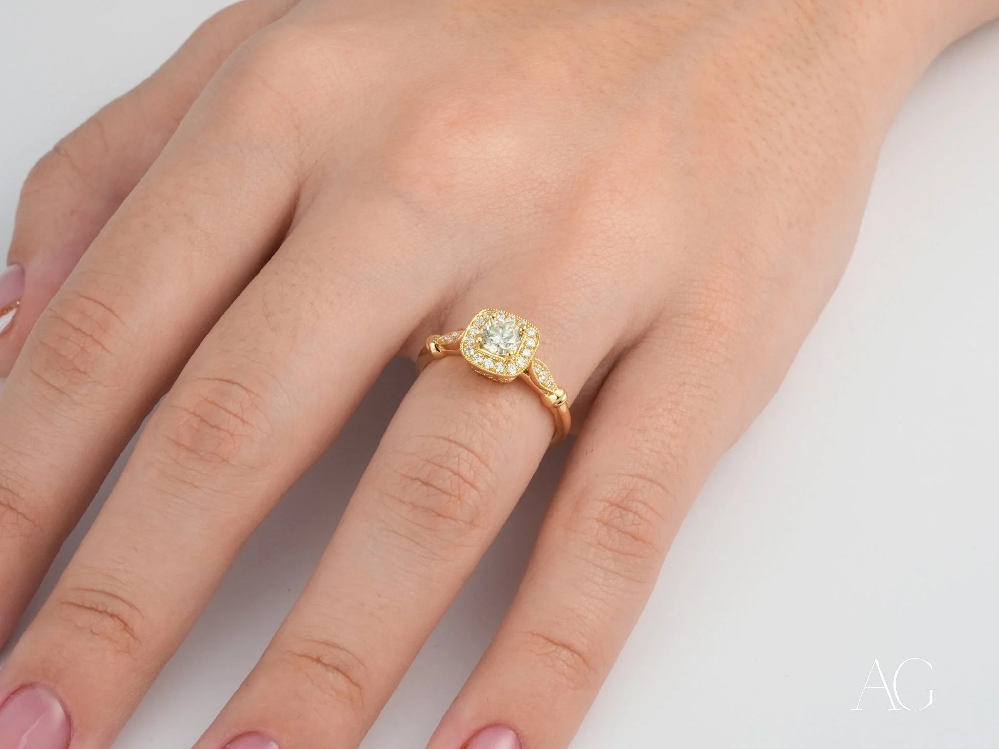 Gold engagement ring featuring a center diamond and halo in 18K yellow gold setting