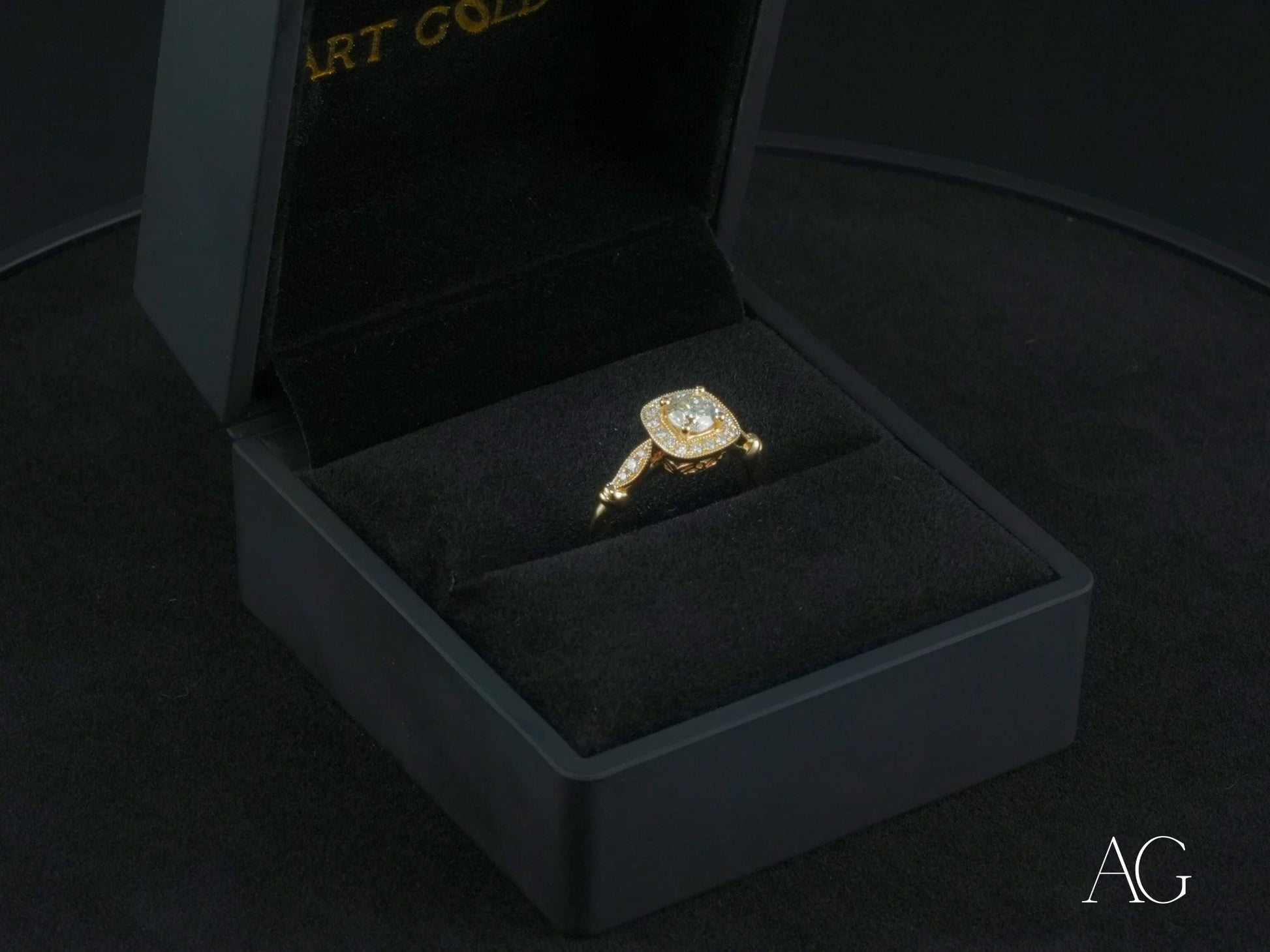 Gold ring with center diamond in 18k yellow gold displayed in black jewelry box