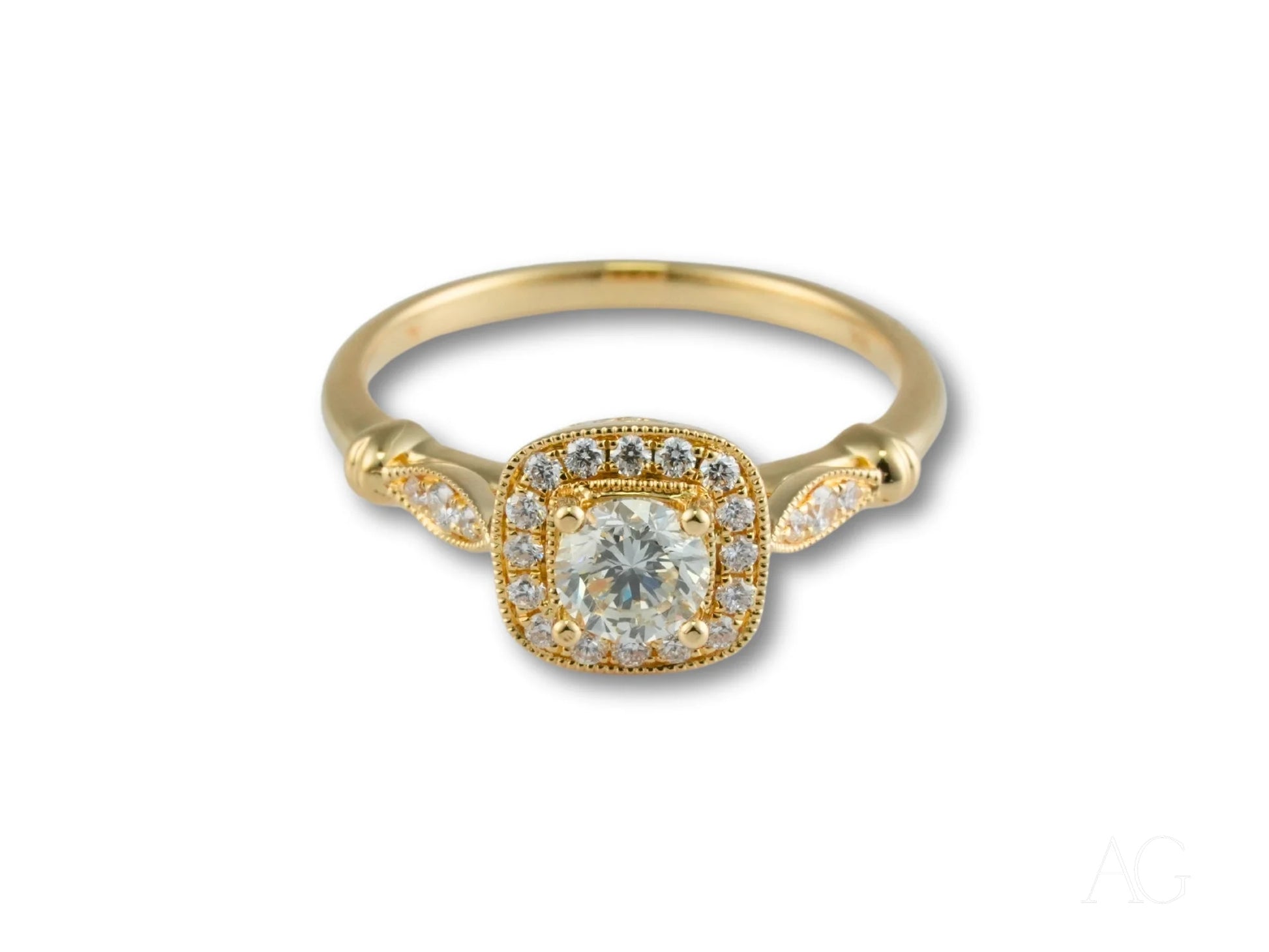 Gold engagement ring featuring a cushion-cut center diamond in 18k yellow gold halo setting