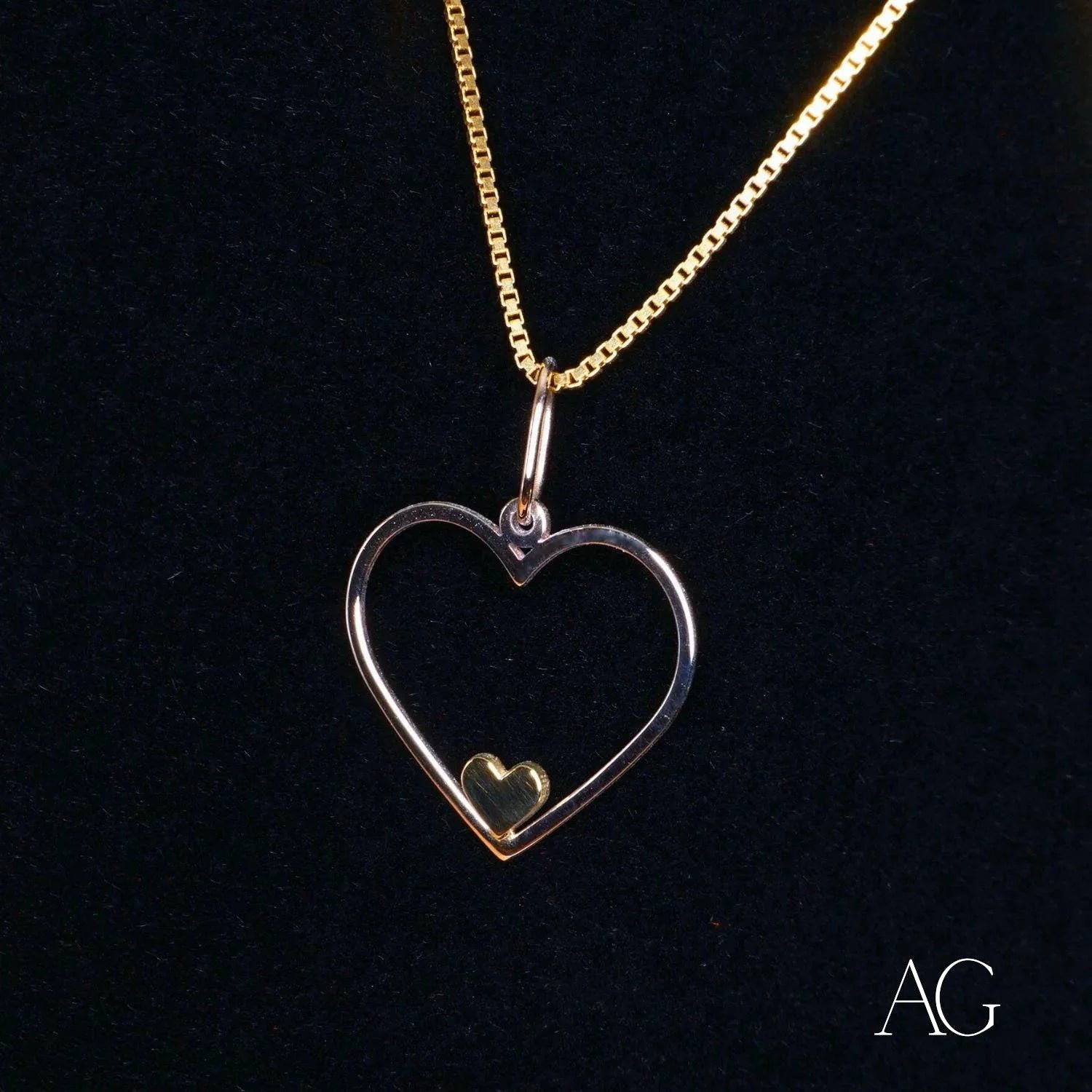 Heartfelt glint pendant featuring a heart-shaped 14k gold necklace with inner heart