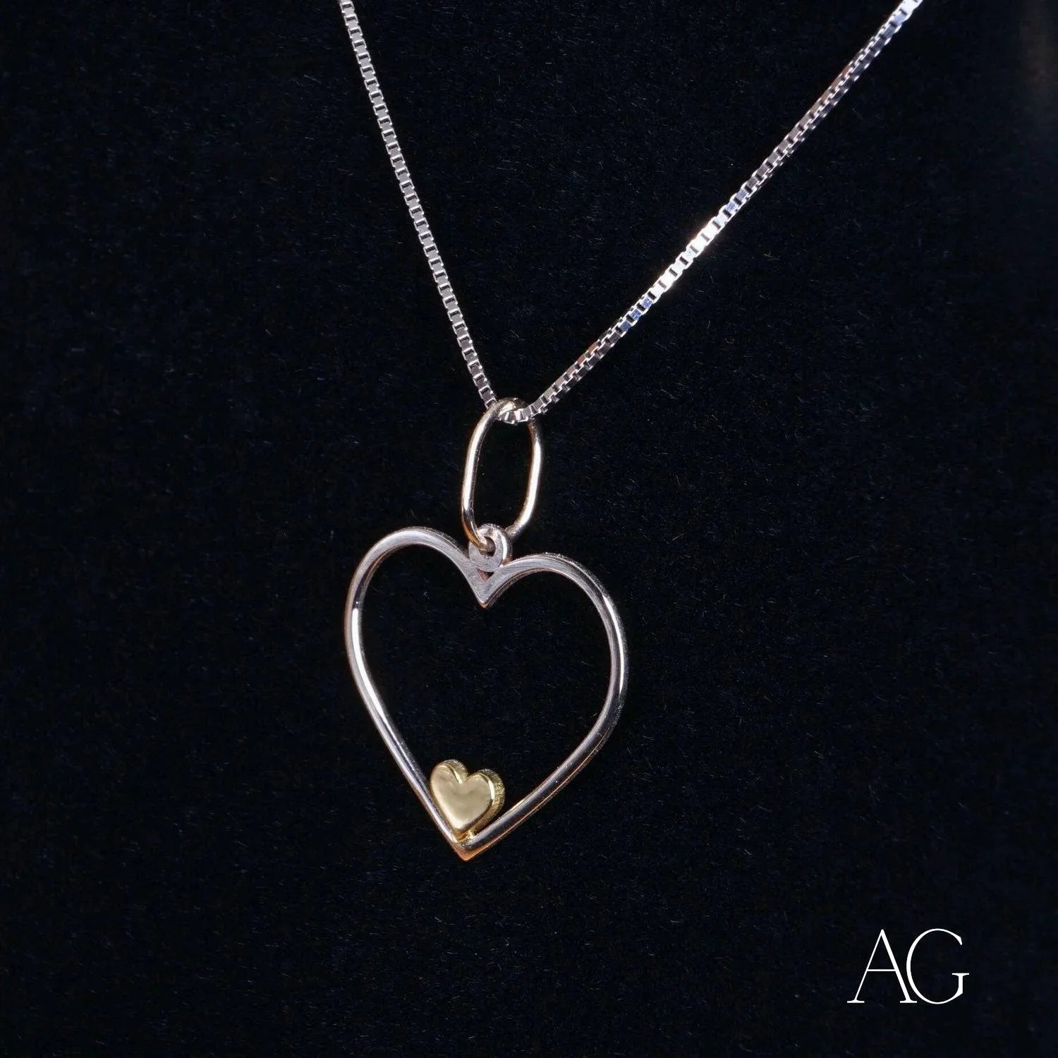 Silver heart-shaped necklace with 14k gold accent, a perfect heartfelt glint pendant