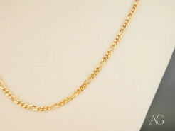 Eternal Prestige 18K Gold Figaro Chain showcasing elegant design and lustrous shine