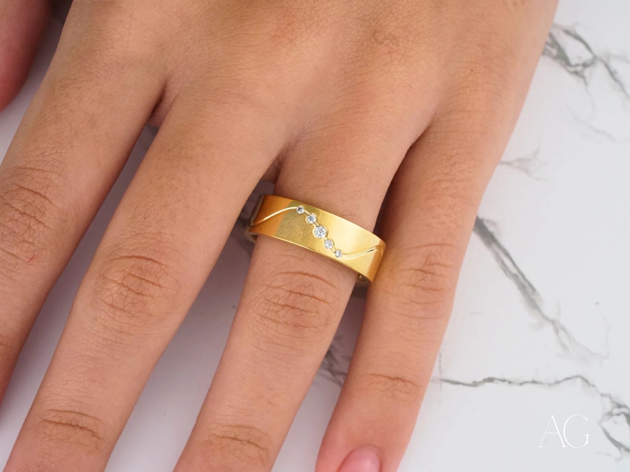 Gold Eternal Wave Wedding Band with Diamonds on a person’s finger in 14k gold