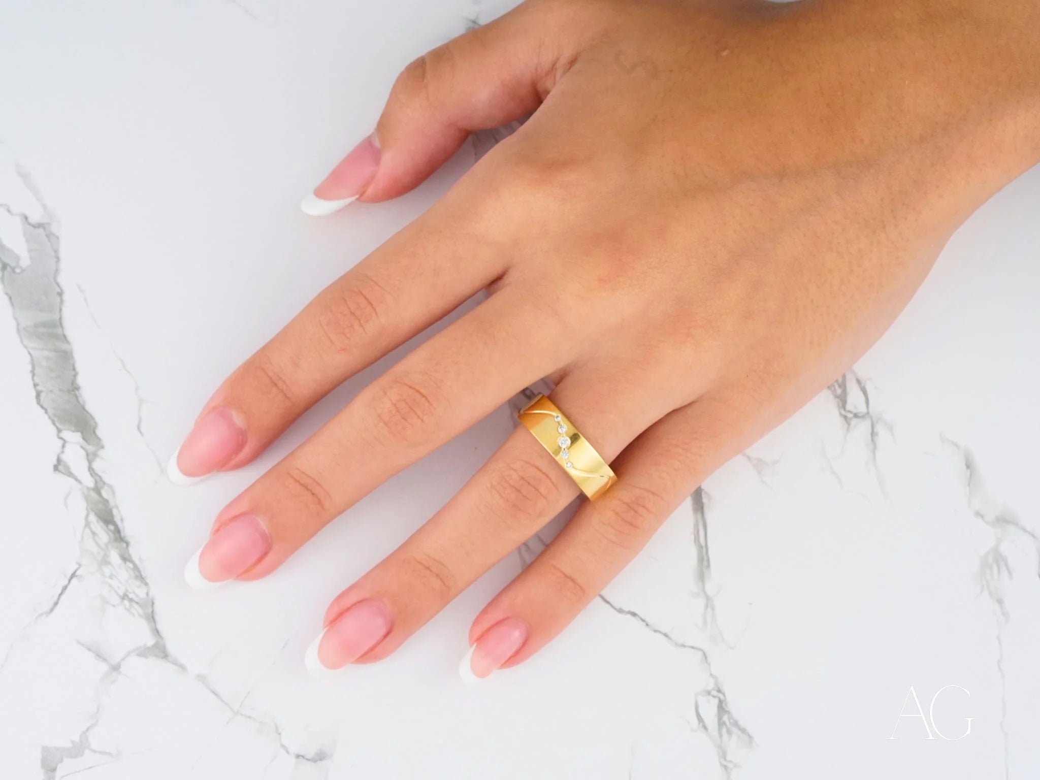 Gold ring featuring the Eternal Wave Wedding Band with Diamonds in 14k gold on manicured fingers