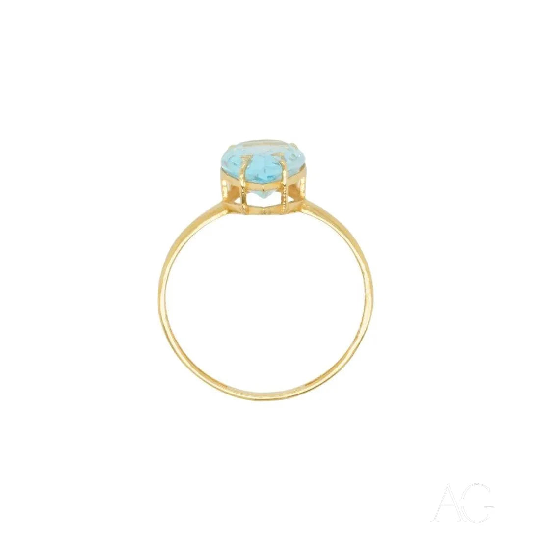 Gold ring featuring a round blue topaz gemstone in a stunning setting