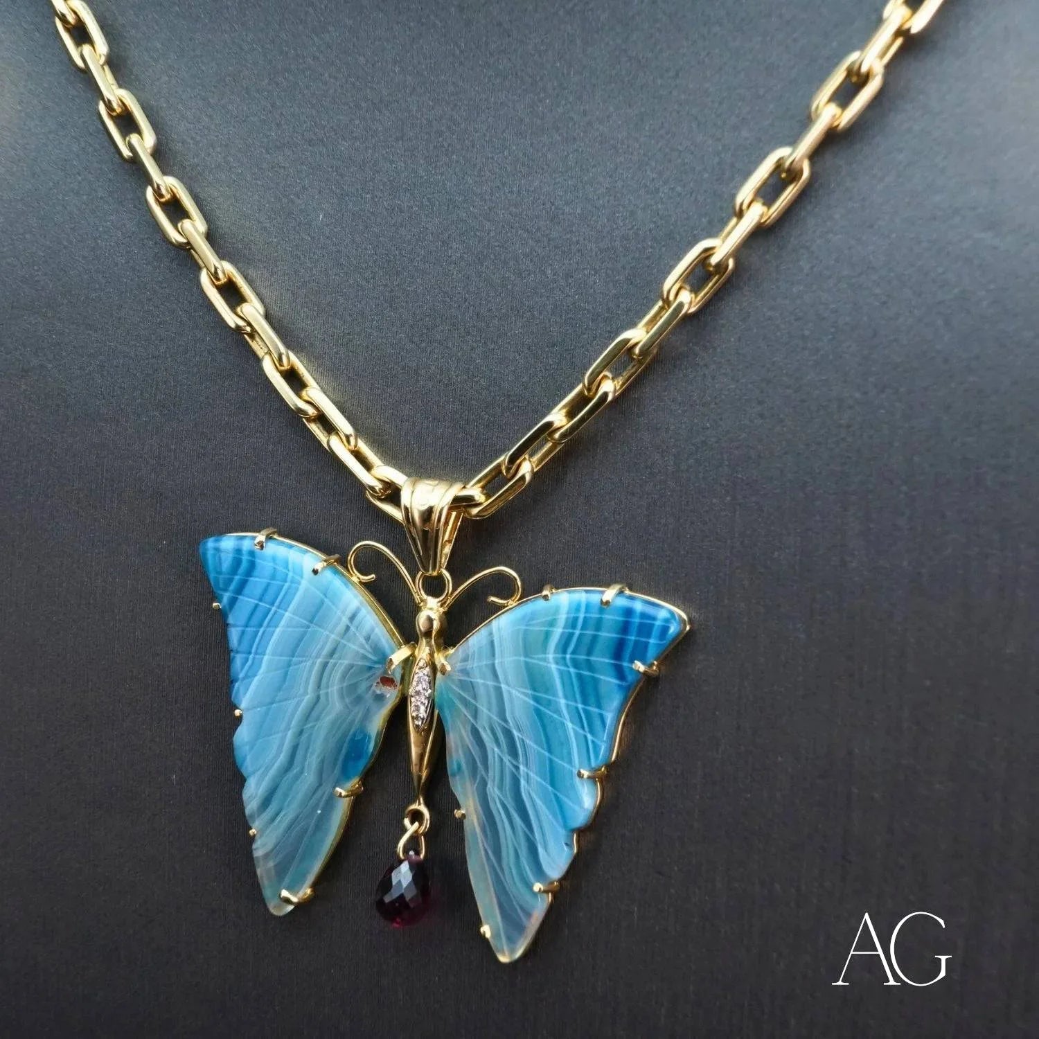 Gold necklace featuring a butterfly pendant with blue agate and diamonds in 18k yellow gold