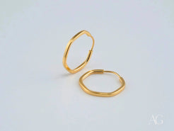 Thin gold-colored hexagonal hoop earrings from Glimmergold 18k mini collection