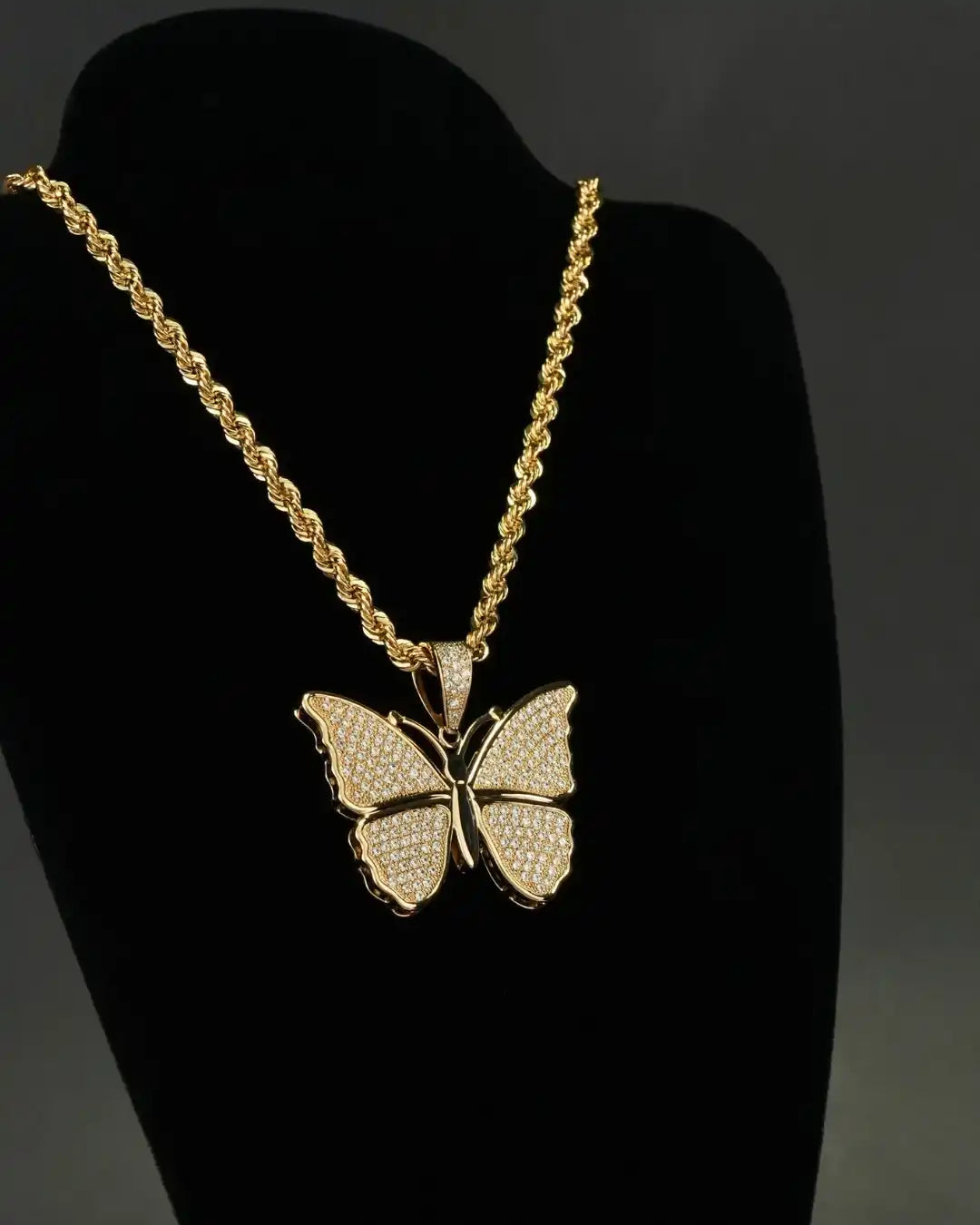 Gold butterfly pendant on a rope chain necklace.