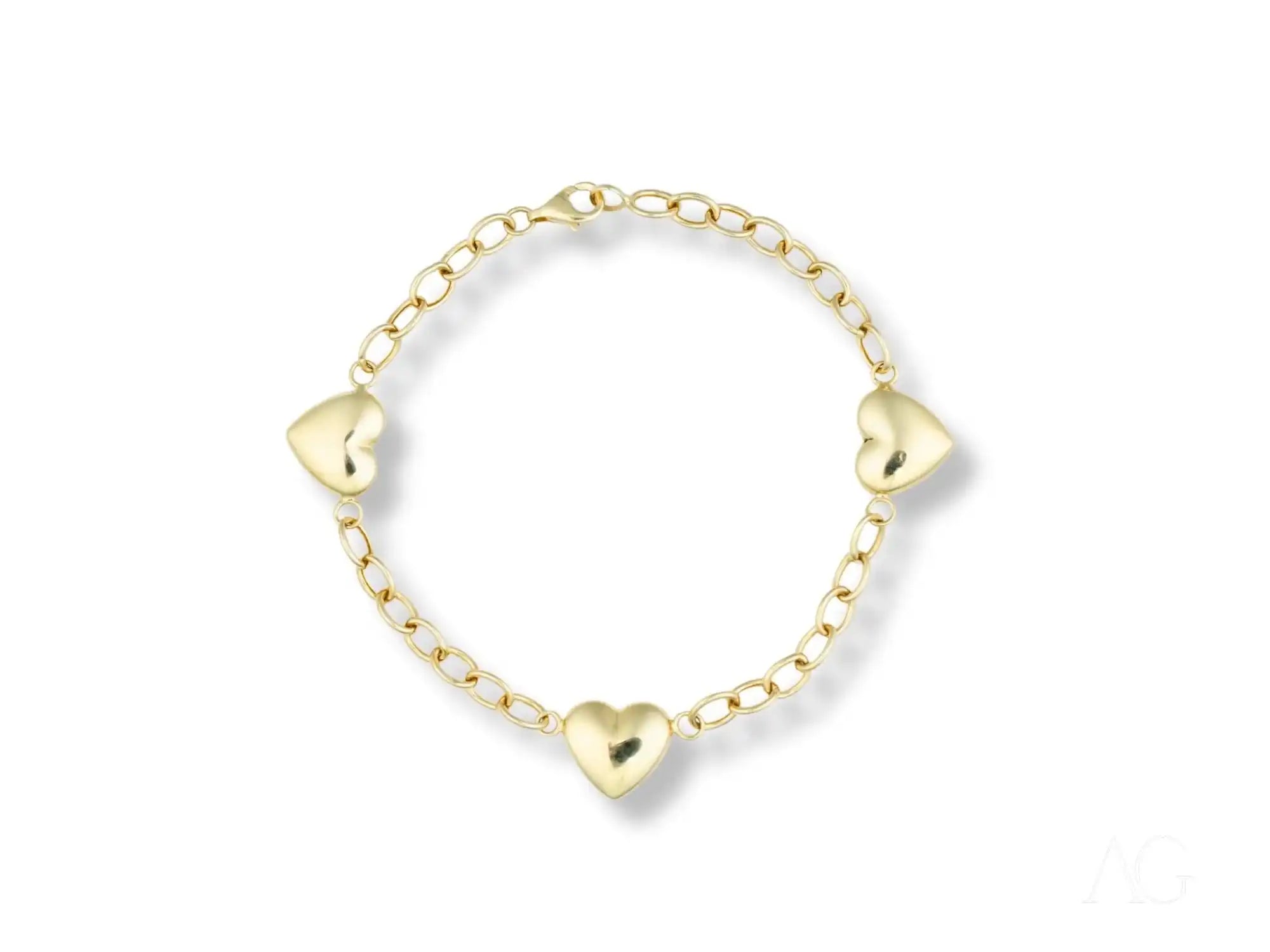 Gold chain bracelet with three heart-shaped charms.