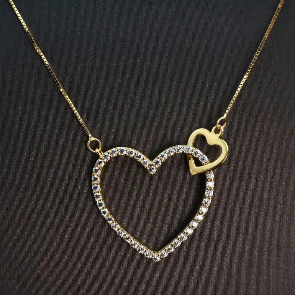 Gold heart pendant necklace adorned with crystals.