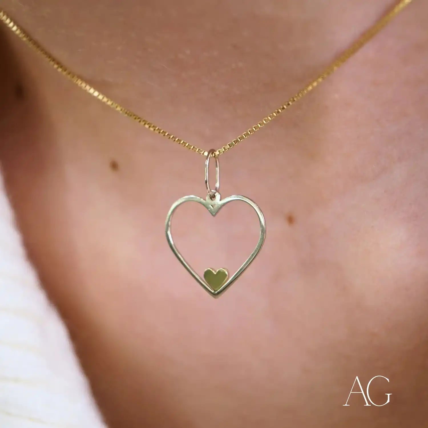 Gold heart-shaped Eternal Love pendant with a heartfelt glint and smaller heart inside