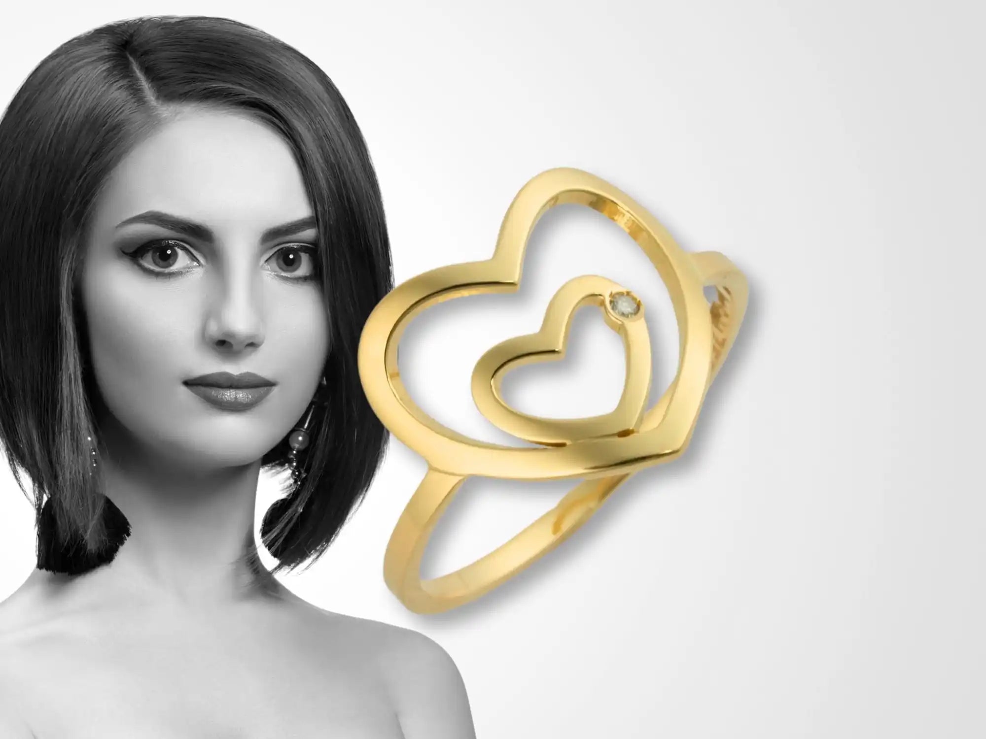 Gold ring featuring two interlinked heart shapes.