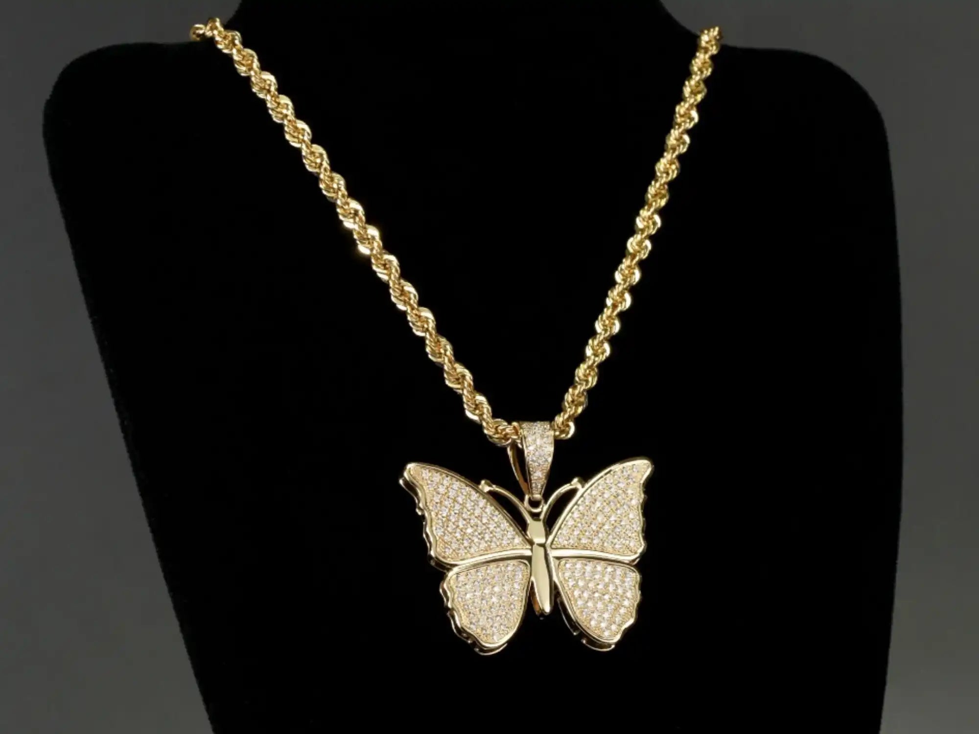 Gold rope chain with diamond butterfly pendant.