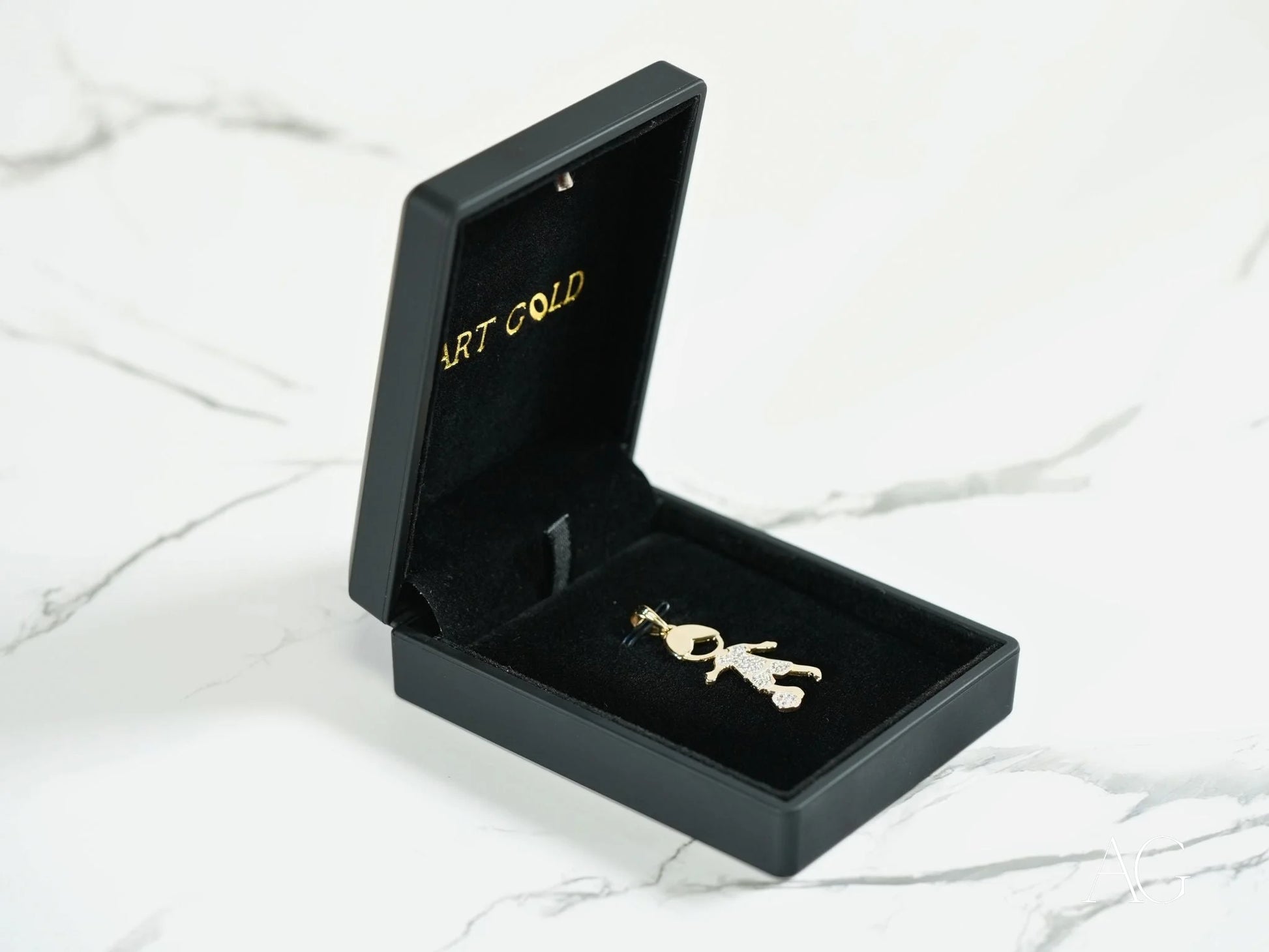 Gold-colored musical note pendant in a black box, part of Golden Moments 18k Gold jewelry