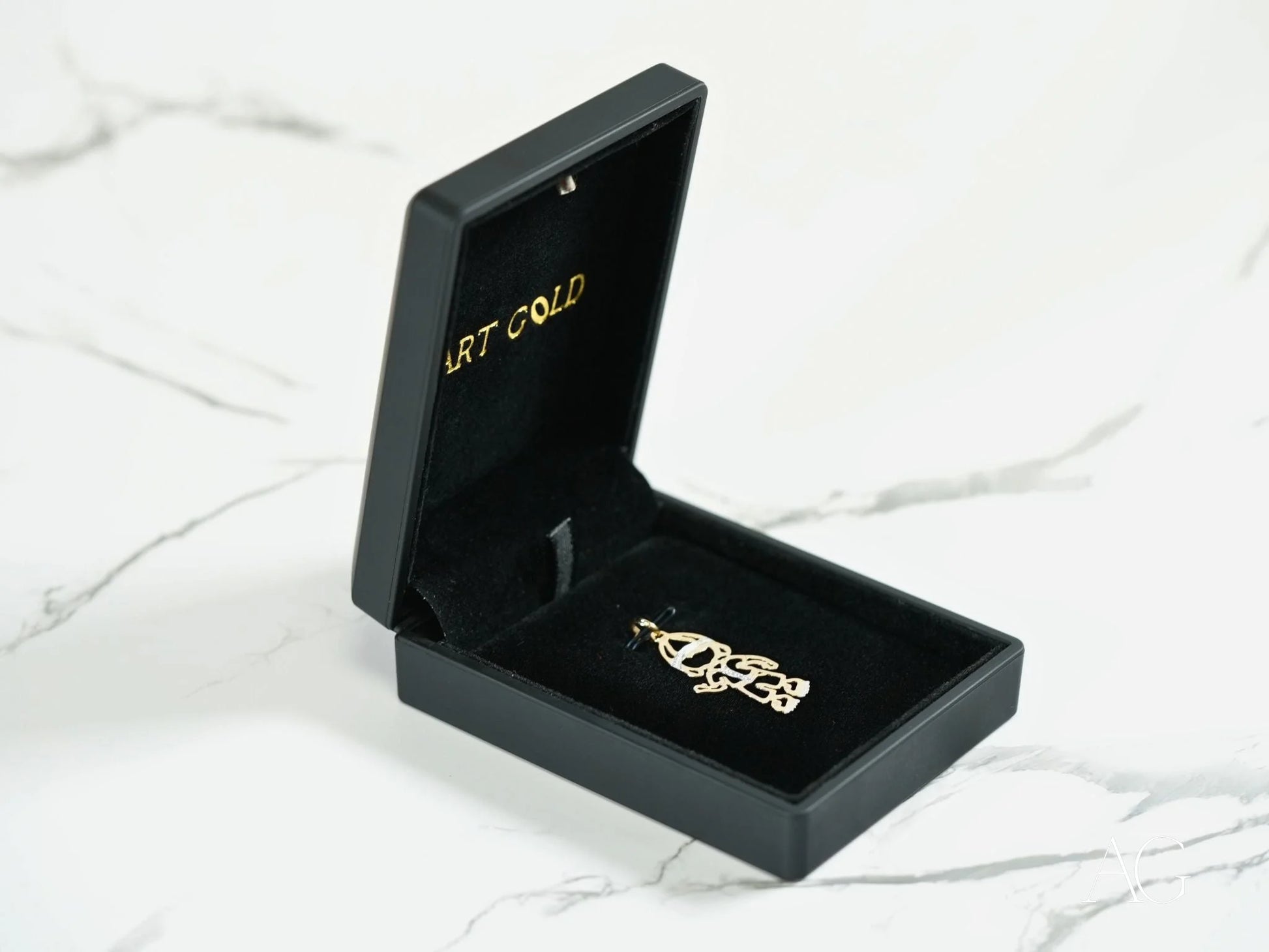 Gold-colored Golden Treasures Pendant in an open black jewelry box showcasing 18k gold