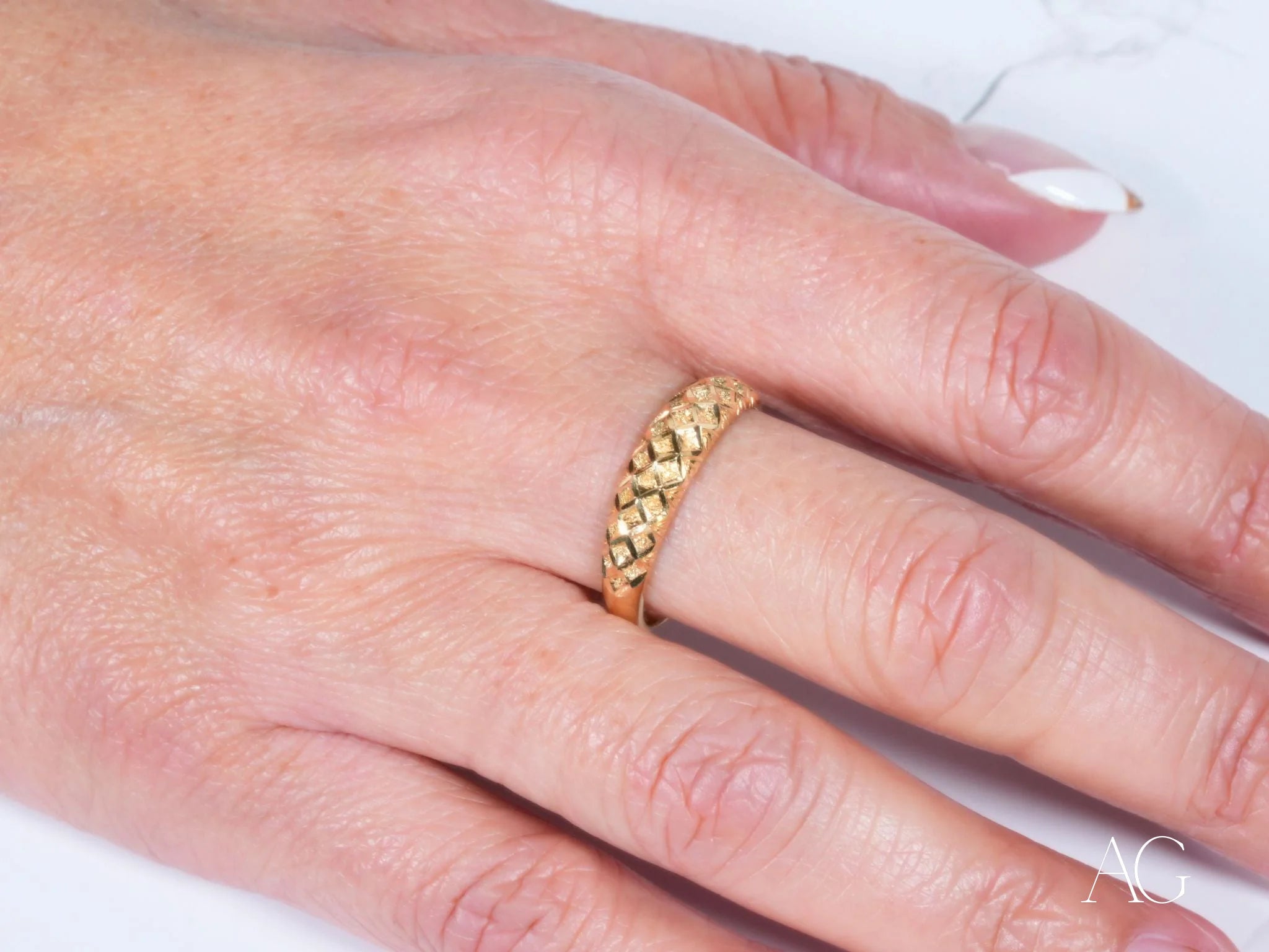 Gold ring with delicate filigree worn on a finger from Golden Grace 18k Aparador Ring