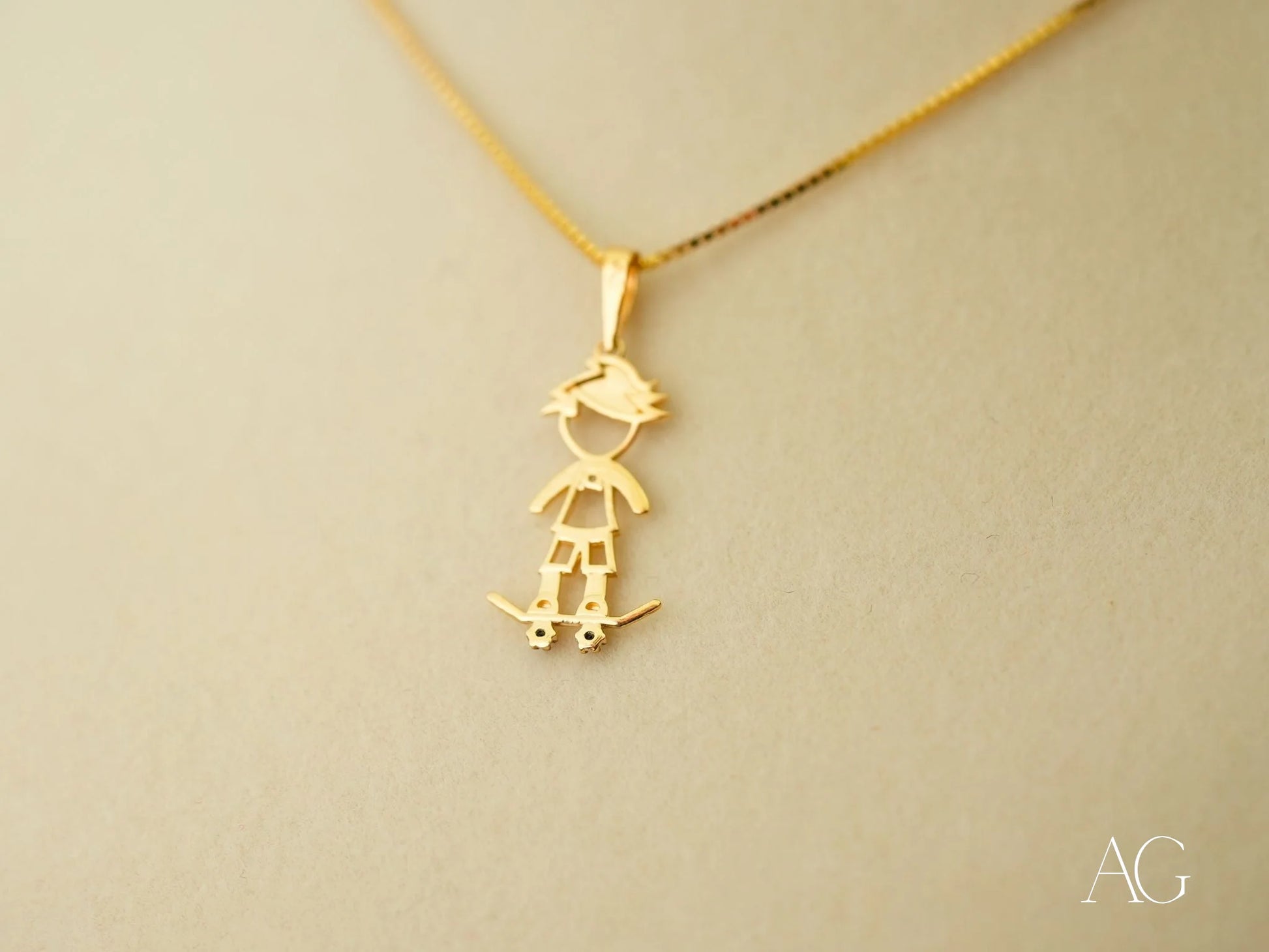 Gold pendant necklace featuring a skateboarding boy charm in 18k gold, Golden Skater