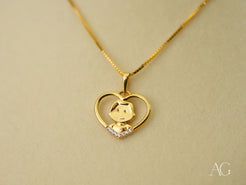 Gold heart-shaped pendant necklace with cartoon character and crystal accent in 18k gold