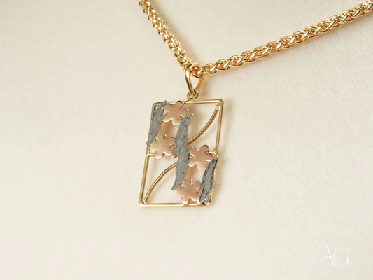 Gold-toned rectangular pendant with floral design on chain necklace from Golden Bloom