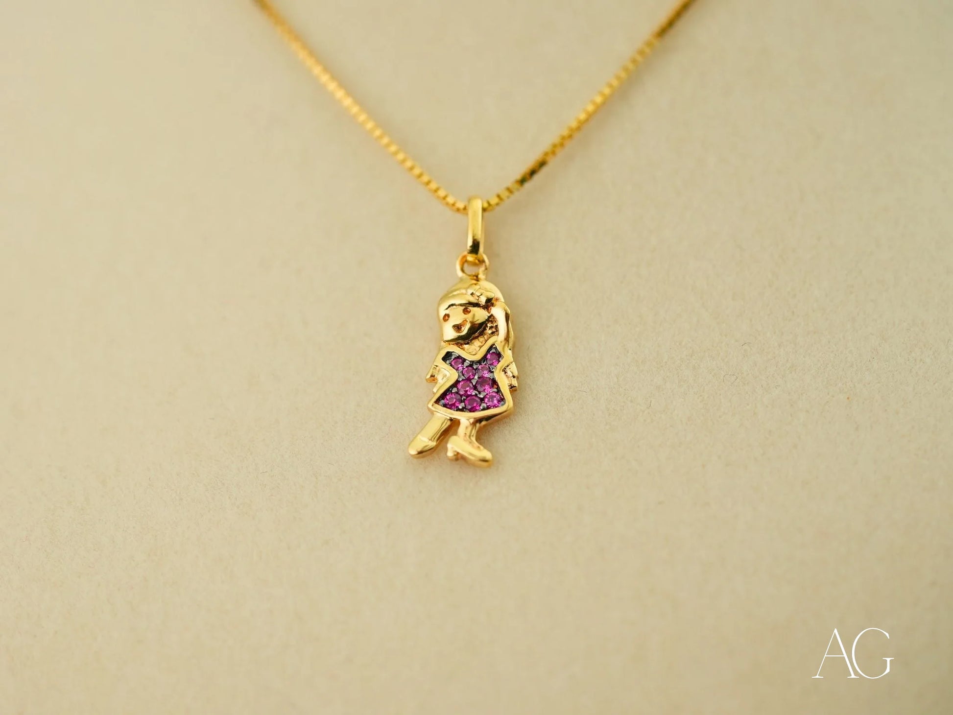 Gold pendant necklace featuring a girl figure in a purple dress from Golden Ruby Doll