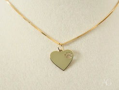 Gold heart-shaped pendant with paw print engraving on 18k gold chain for pet lovers