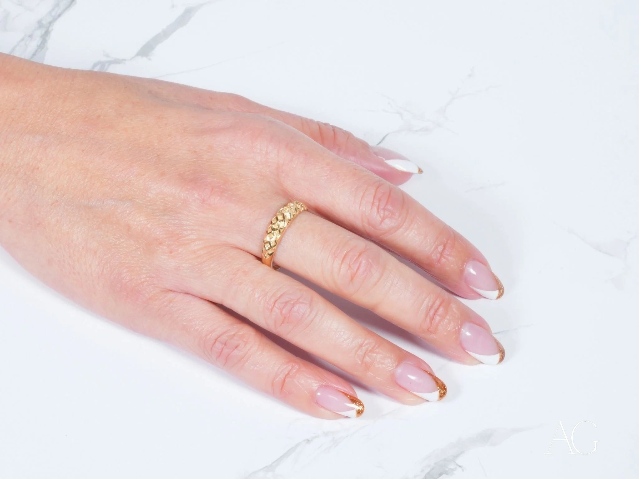 Gold ring with decorative details on hand with French manicured nails, Golden Grace 18k Aparador Ring