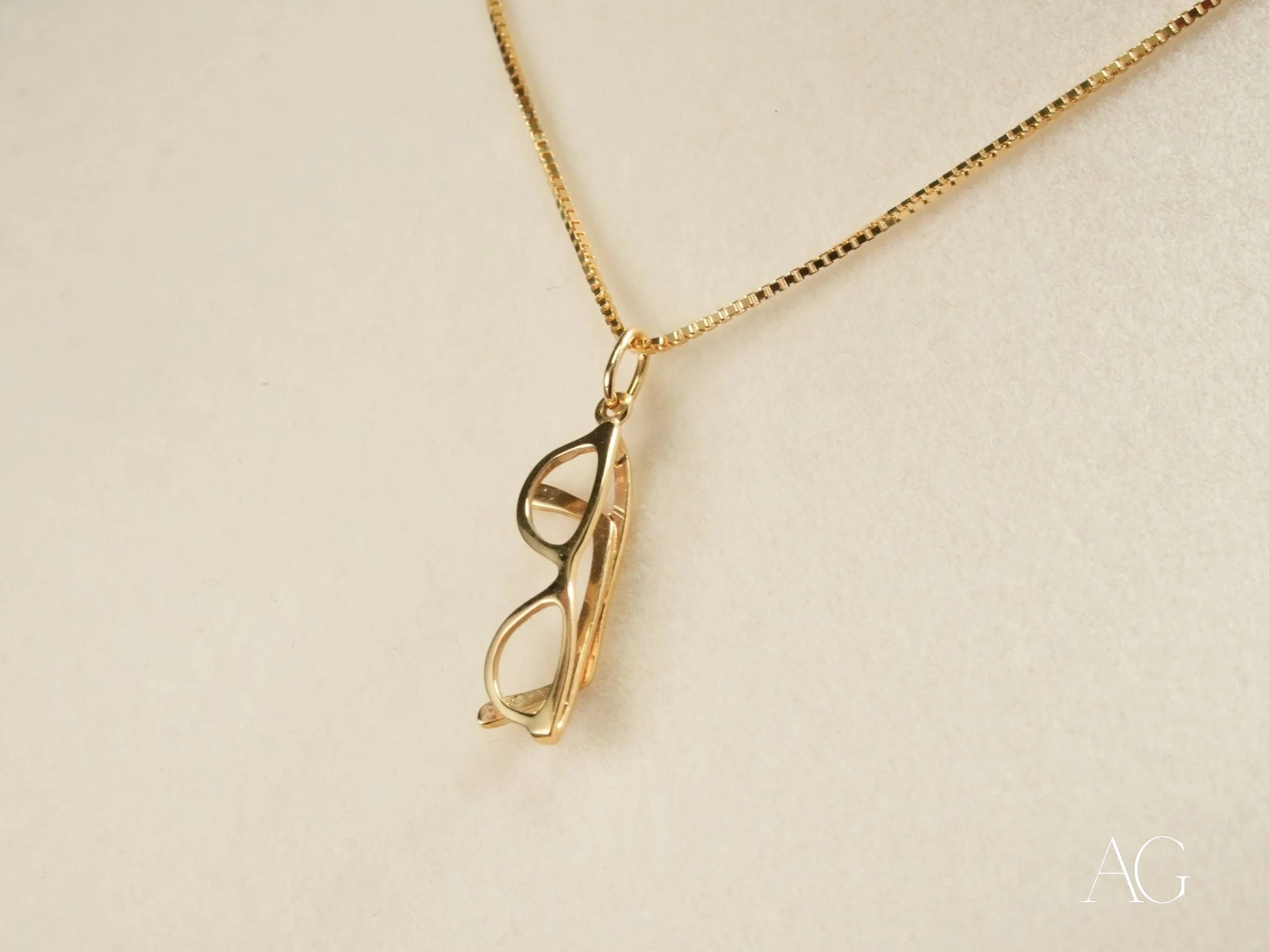 Gold-toned 18k gold glasses pendant necklace on a delicate chain from Golden Vision