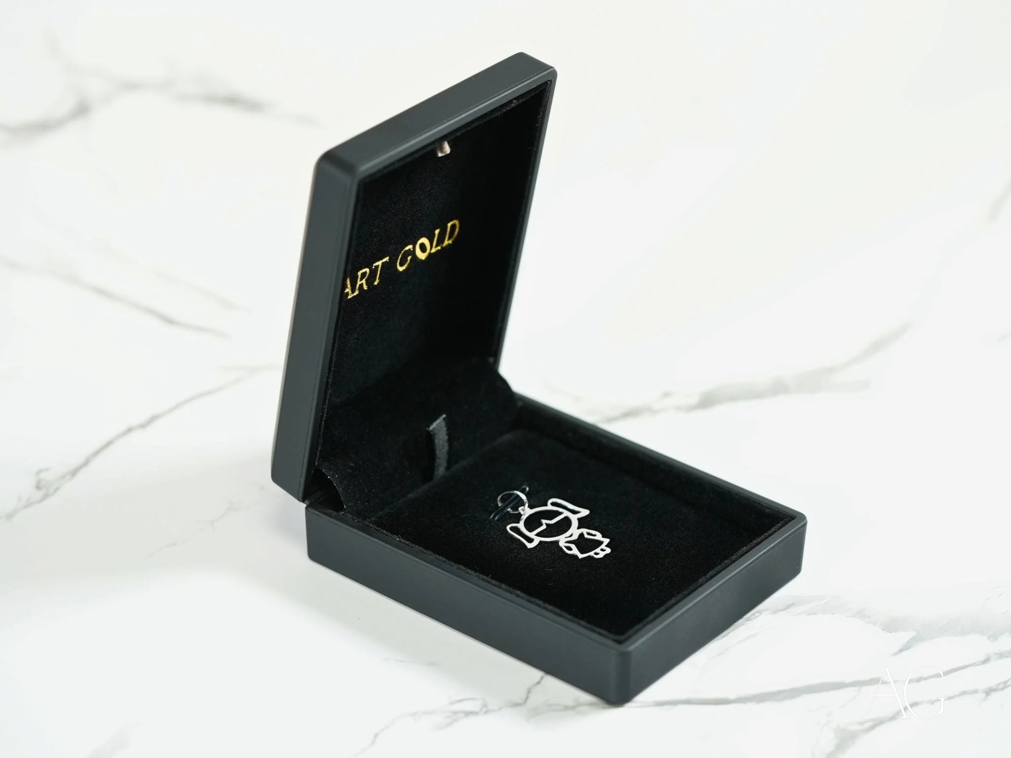 Black jewelry box with a silver ring for the Golden Doll 18k Yellow or White Gold Pendant