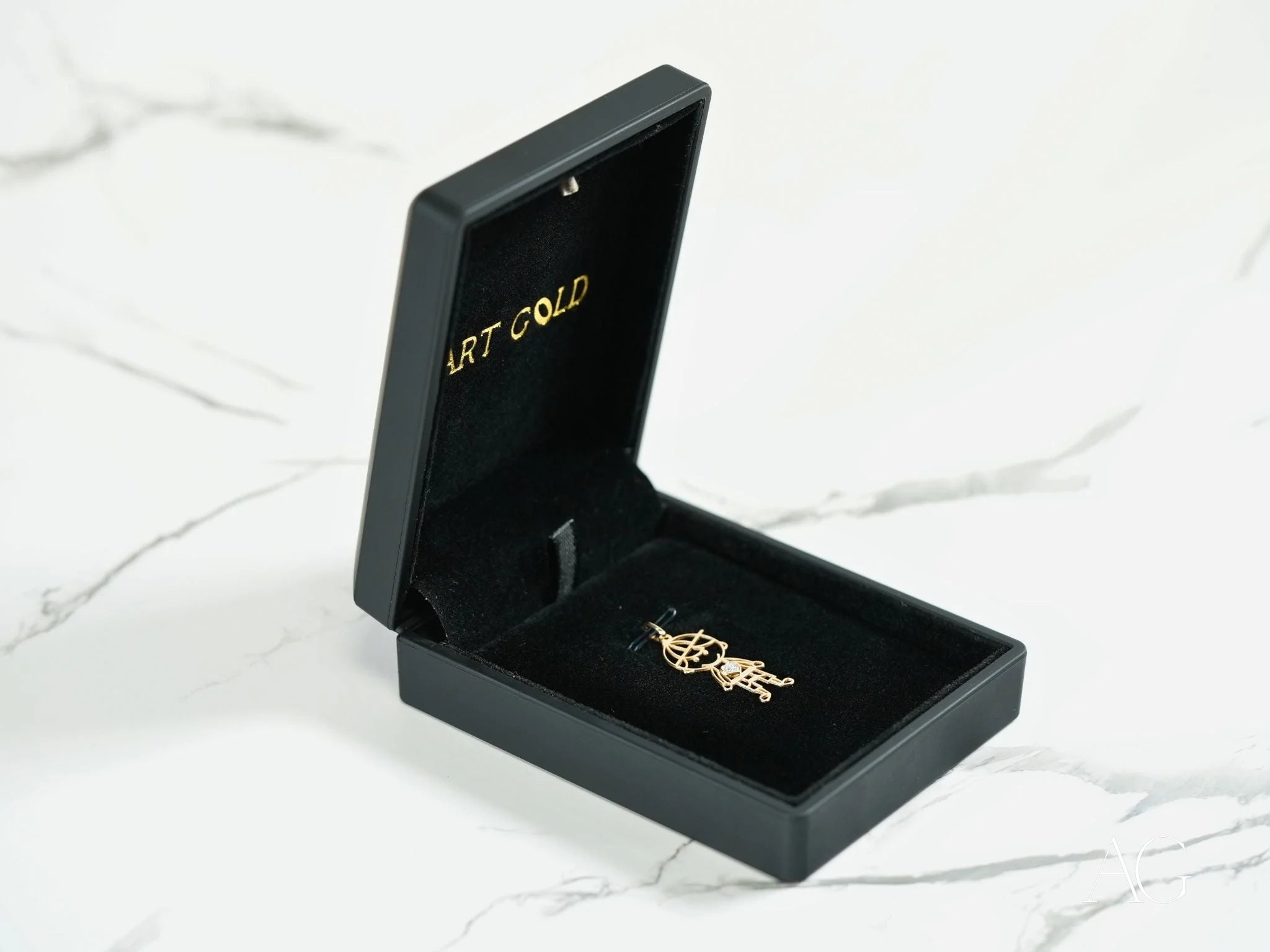 Gold-colored jewelry brooch in a black box featuring 18k Gold Golden Heart design