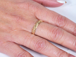 18k Gold Golden Grace Aparador Ring with intricate woven pattern worn on a finger