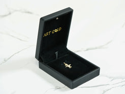 Gold cross pendant in a black jewelry box for the 18k Gold Doll Pendant gift