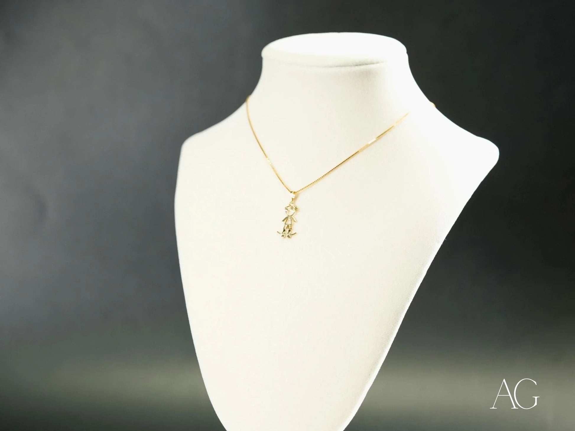 Gold necklace with Golden Skater pendant on a white jewelry bust, crafted in 18k gold