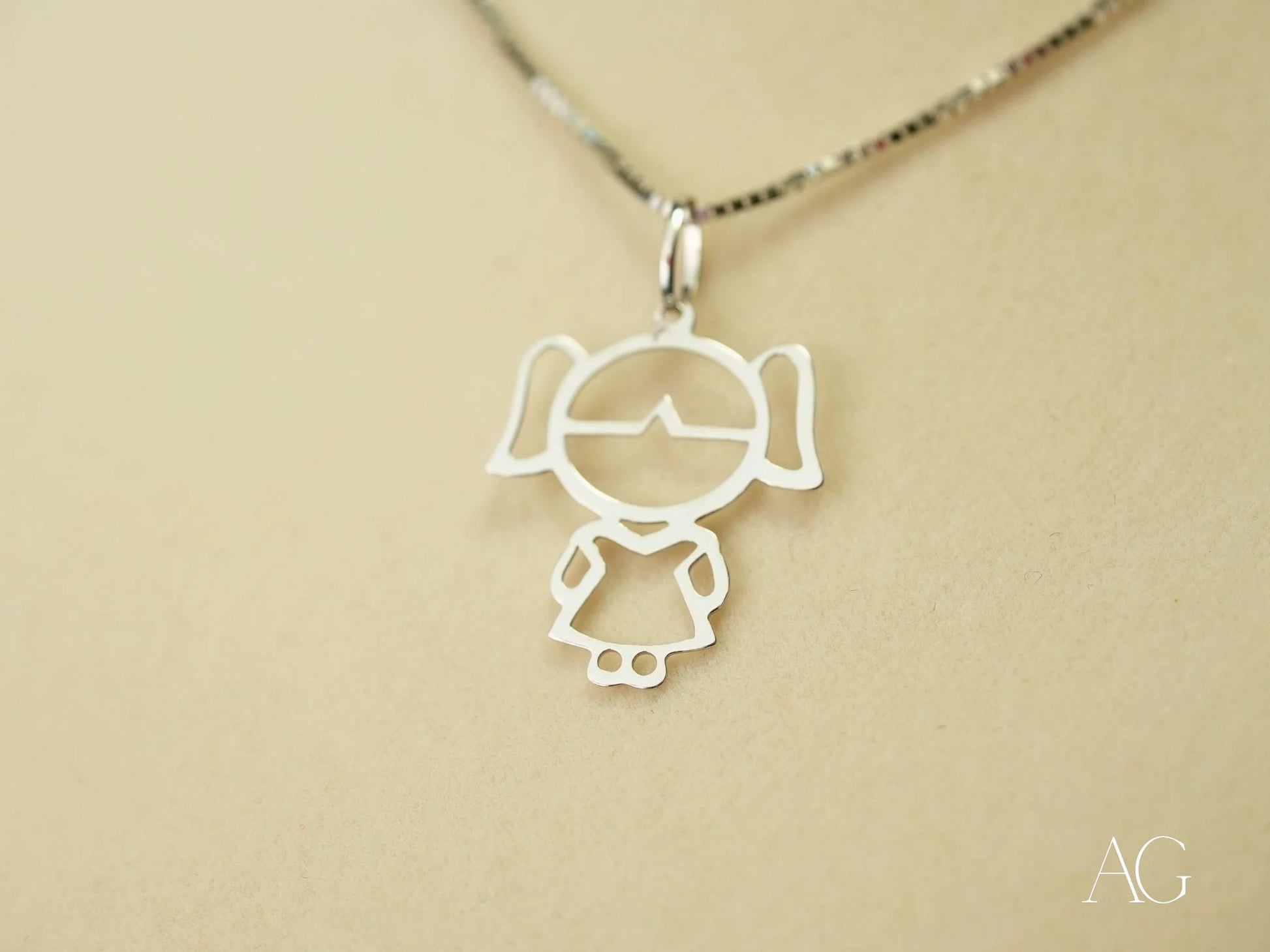 Silver pendant necklace with minimalist girl figure design from Golden Doll collection