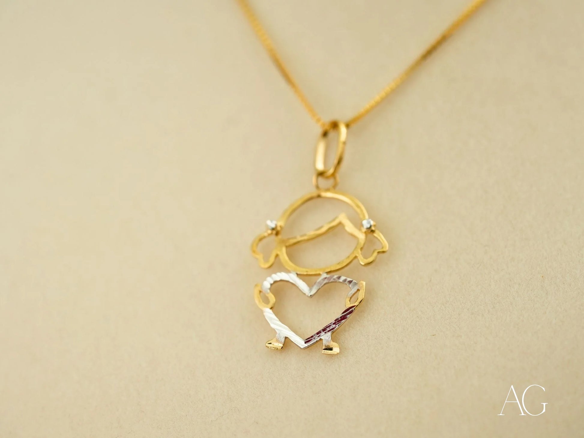 Gold pendant necklace with a girl figure outline, part of the 18k Gold Heart Doll collection