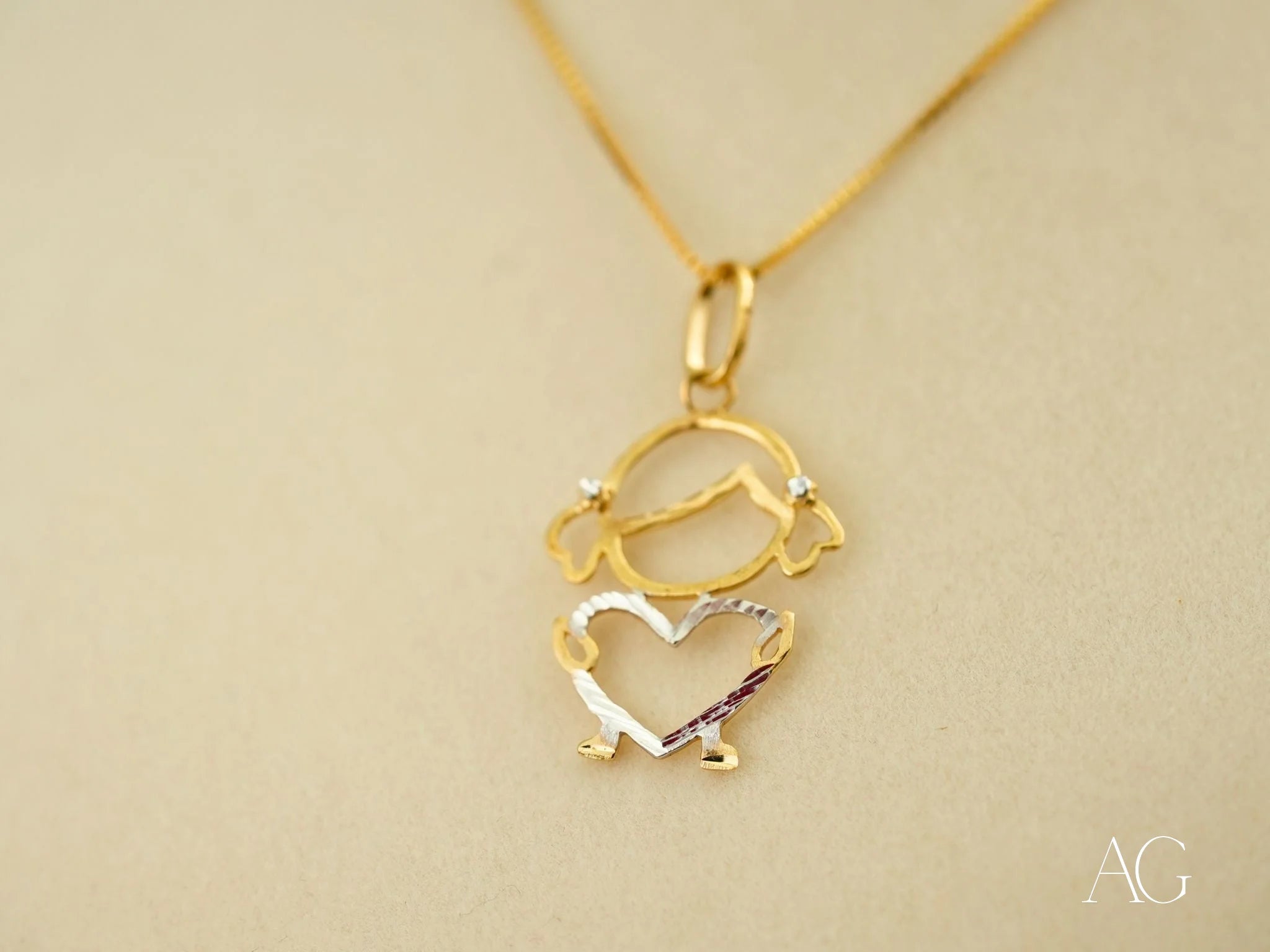 Gold pendant necklace with a girl figure outline, part of the 18k Gold Heart Doll collection