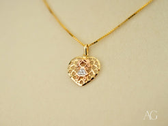 Gold heart-shaped doll pendant with filigree design and diamond on 18k gold chain