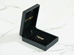 Elegant black jewelry box with gold lettering for Golden Skater Pendant in 18k gold