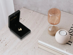 Ring box featuring a golden heart heartbeat pendant in 18k gold