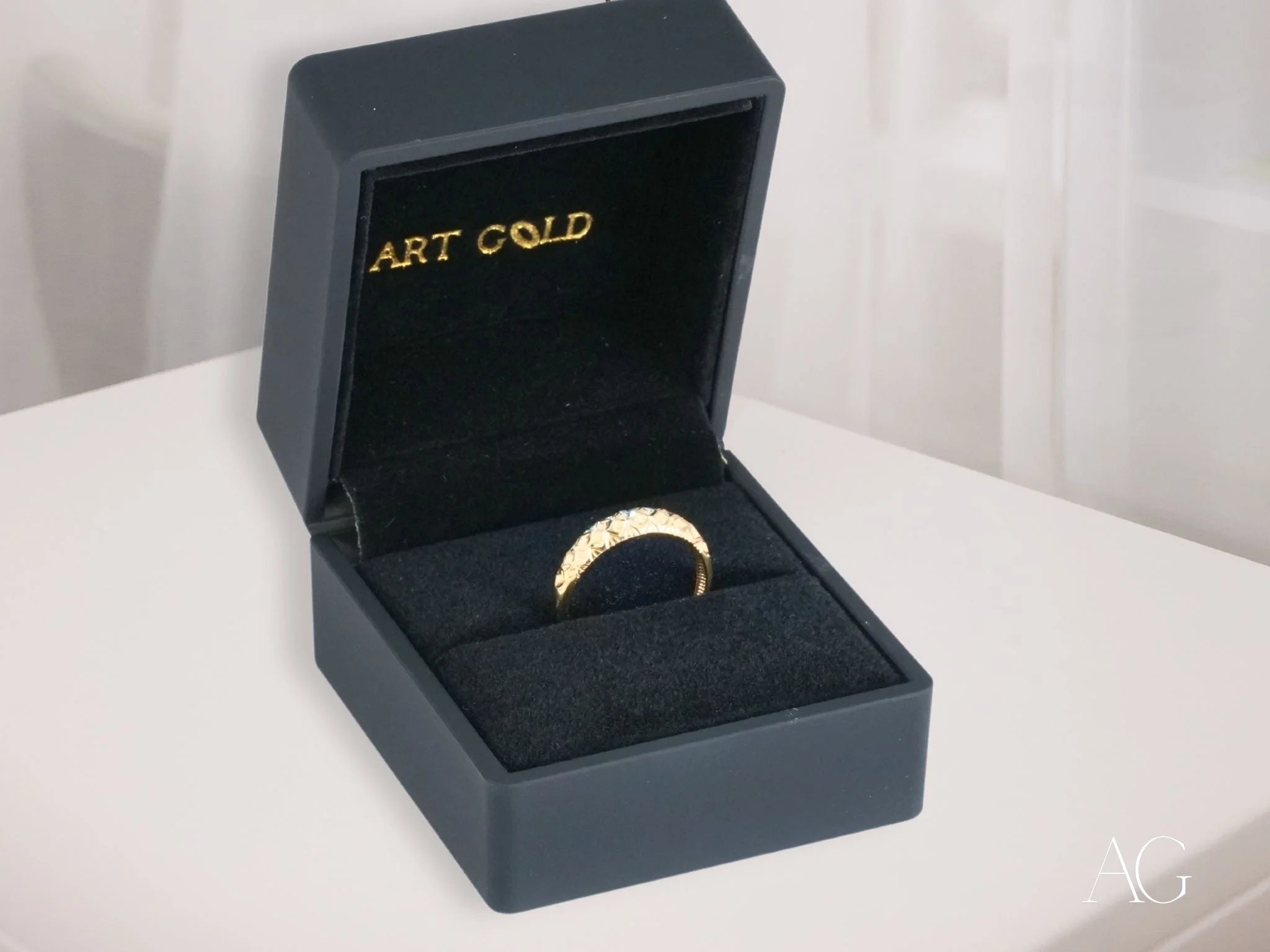 Gold ring with diamonds in a dark box for the Golden Grace 18k Aparador Ring