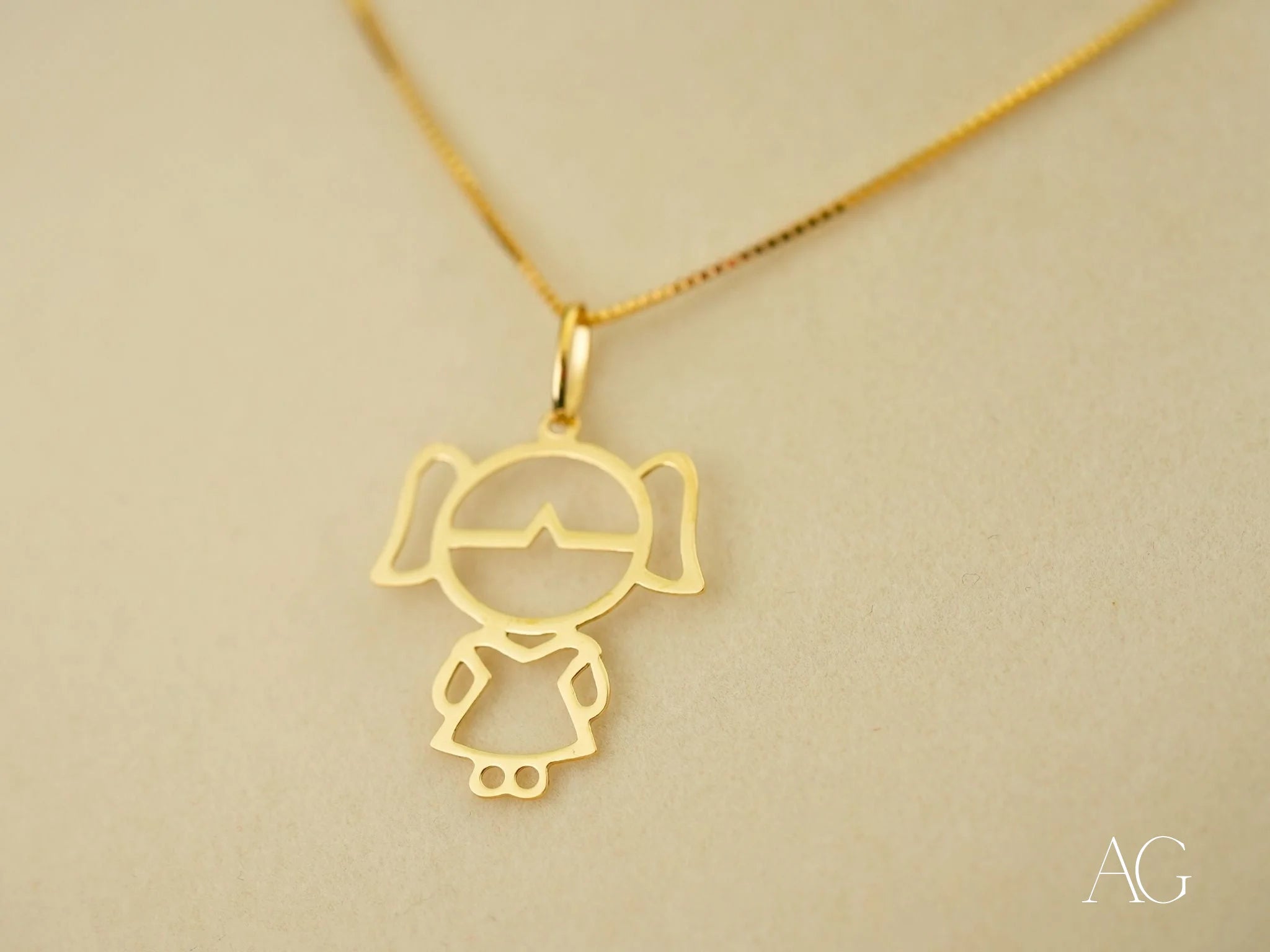 Gold pendant necklace featuring a minimalist stick figure design, Golden Doll in 18k yellow gold