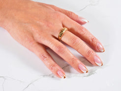 Hand adorned with 18k gold Golden Mesh Elegance Ring and French manicured nails