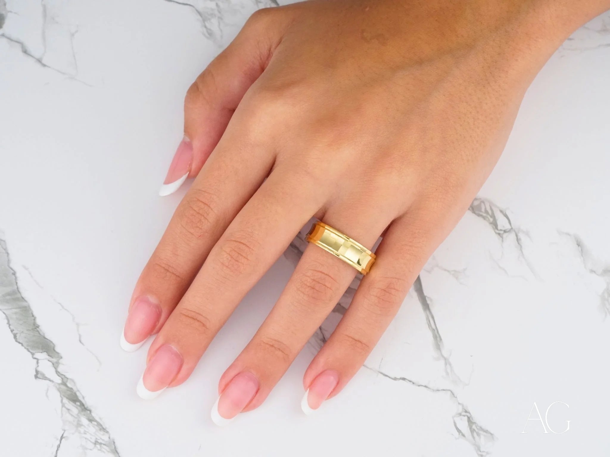 14k gold Golden Cascade Wedding Band with textured band worn on a finger