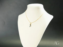 Gold necklace with Golden Charm CZ Doll Pendant in 18k yellow gold on white bust