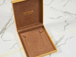 Gold chain necklace presented in a box, showcasing 18K Yellow Gold Basic Link Chain