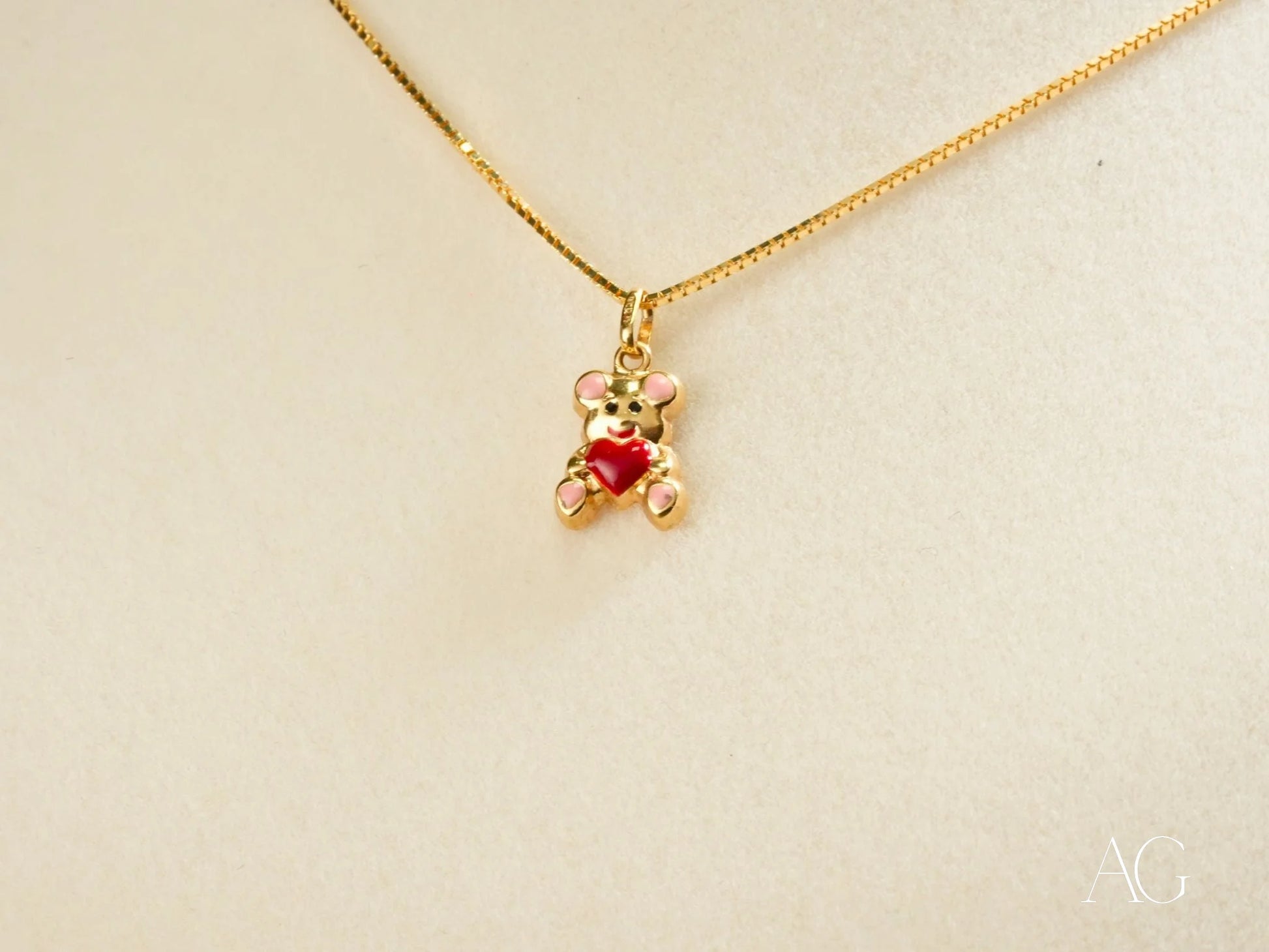 Golden Cub Bear Pendant in 18k gold with a red heart on a delicate chain necklace